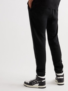 AMIRI - Slim-Fit Tapered Logo-Print Cotton-Jersey Sweatpants - Black