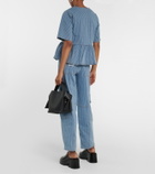 Ganni Striped bow-trimmed peplum denim blouse