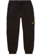 Stone Island - Tapered Logo-Appliquéd Garment-Dyed Fleece-Back Cotton-Jersey Sweatpants - Black