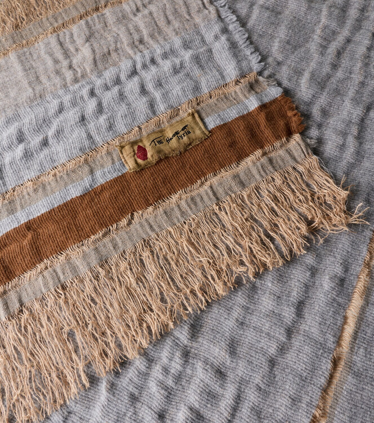 The House of Lyria Xoroi striped jute and wool-blend throw