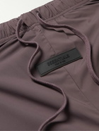 FEAR OF GOD ESSENTIALS - Tapered Logo-Appliquéd Padded Shell Drawstring Trousers - Purple