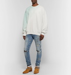 AMIRI - Skinny-Fit Distressed Paint-Splattered Stretch-Denim Jeans - Light blue