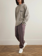 FEAR OF GOD ESSENTIALS - Tapered Logo-Appliquéd Padded Shell Drawstring Trousers - Purple