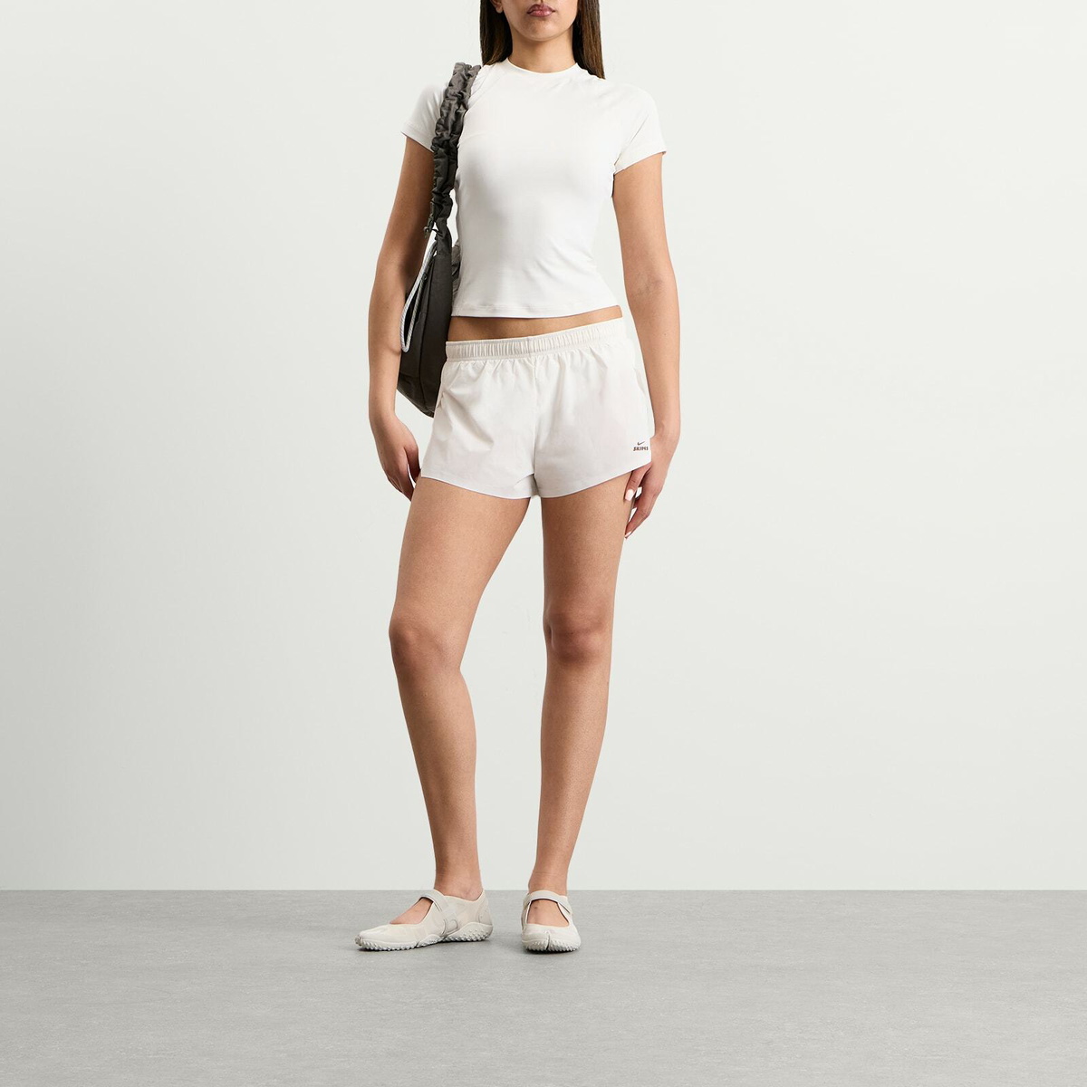 Nike Women's x SKIMS Stretch Nylon Runner Short in Ivory