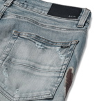 AMIRI - Skinny-Fit Distressed Appliquéd Panelled Stretch-Denim Jeans - Blue