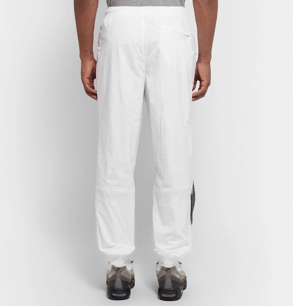NIKE Solo Swoosh Tapered Logo-Embroidered Nylon Track Pants for