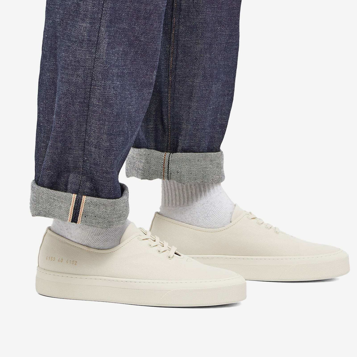 Woman by Common Projects Women's Four Hole Canvas Sneakers in Off White ...