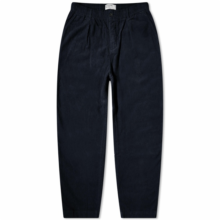 Photo: Universal Works Men's Corduroy Pleated Track Pant in Navy