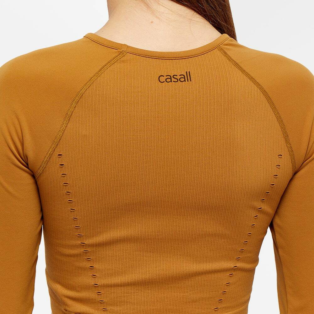 Casall Women's Long Sleeve Seamless Femme Crop Top in Brass Yellow