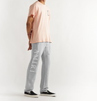 AMIRI - Tapered Logo-Print Mélange Loopback Cotton-Jersey Sweatpants - Gray