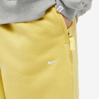Nike Men's Solo Swoosh Fleece Pant in Saturn Gold/White