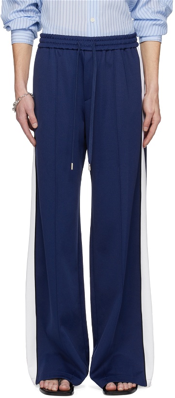 Photo: System Blue Piping Track Pants