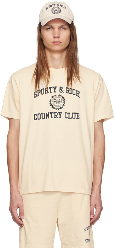 Photo: Sporty & Rich Off-White Varsity Crest T-Shirt.