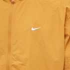 Nike Men's Solo Swoosh Woven Track Jacket in Desert Ochre/White