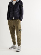 Stone Island - Tapered Logo-Appliquéd Garment-Dyed Fleece-Back Cotton-Jersey Sweatpants - Green