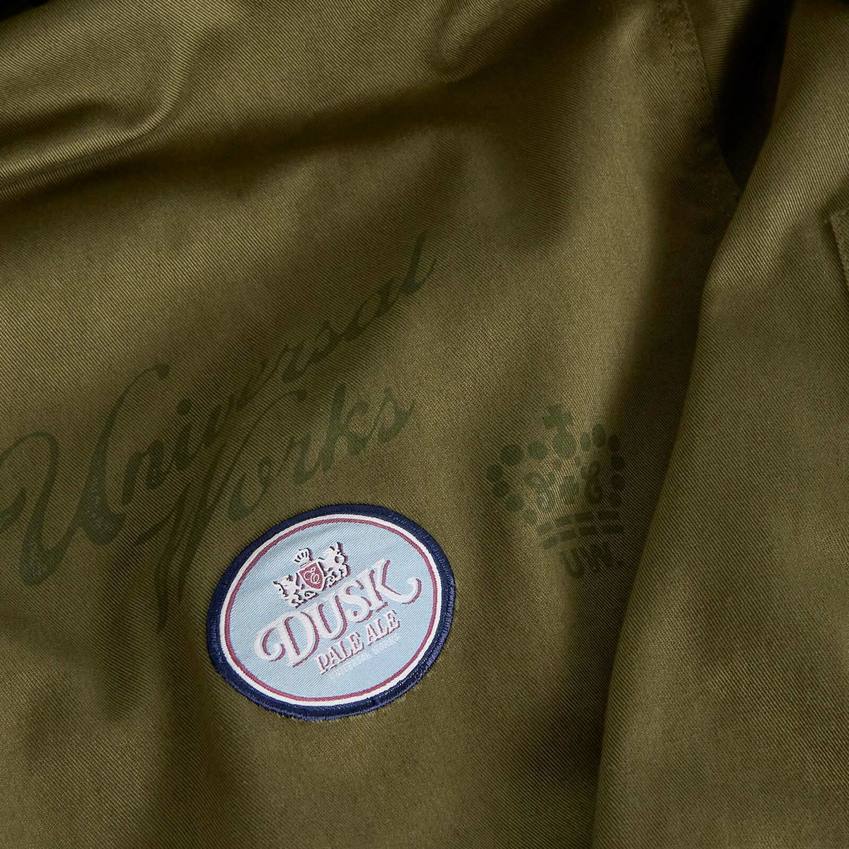 END. x Universal Works Men's Shipp Inn Parka Jacket in Light Olive