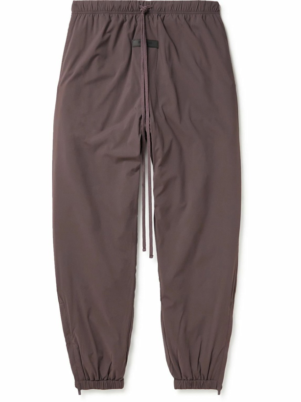 Photo: FEAR OF GOD ESSENTIALS - Tapered Logo-Appliquéd Padded Shell Drawstring Trousers - Purple