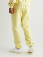 FEAR OF GOD ESSENTIALS - Tapered Logo-Flocked Cotton-Blend Jersey Sweatpants - Yellow