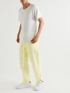 FEAR OF GOD ESSENTIALS - Tapered Logo-Appliquéd Taslan Nylon Track Pants - Yellow