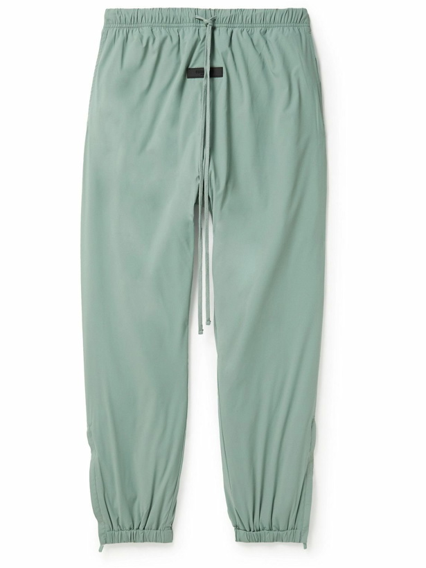Photo: FEAR OF GOD ESSENTIALS - Tapered Logo-Appliquéd Padded Stretch-Shell Drawstring Trousers - Green