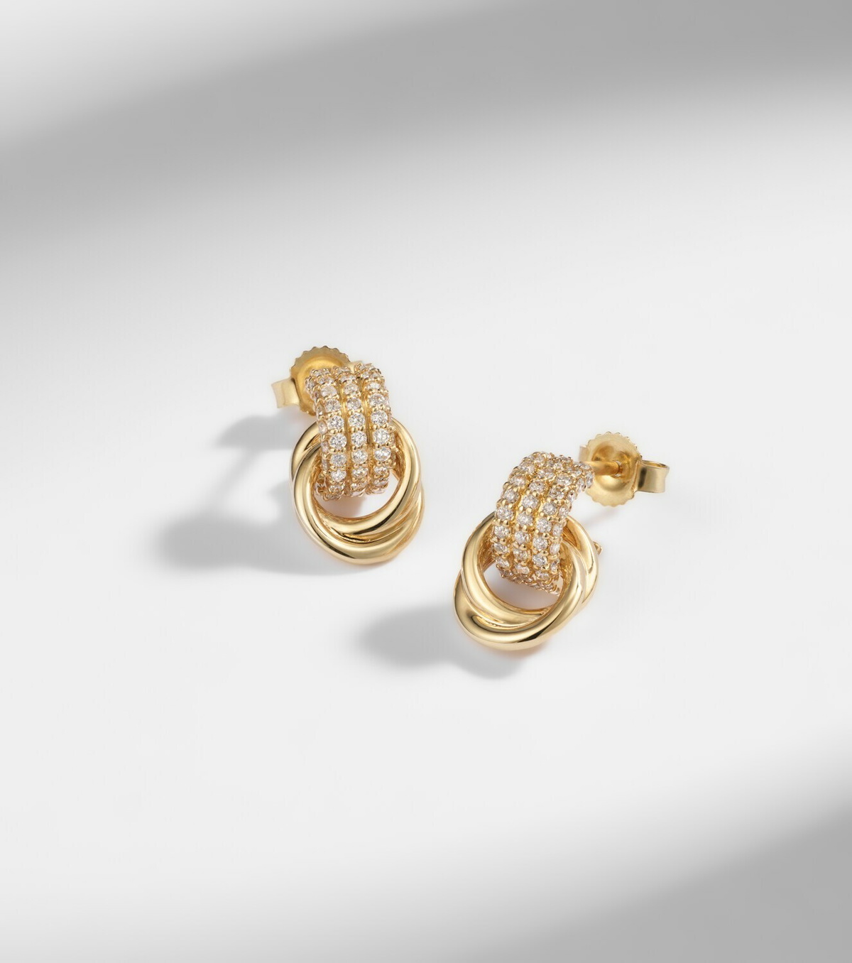 Stone and Strand Forme Knot 14kt gold earrings with diamonds