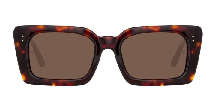 Photo: Linda Farrow Nieve Dark T-shell / Yellow Gold Sunglasses