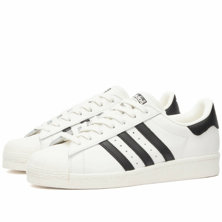 Photo: Adidas Men's Superstar 82 Sneakers in Cloud White/Core Black/Off White