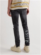 AMIRI - Skinny-Fit Logo-Print Distressed Jeans - Black