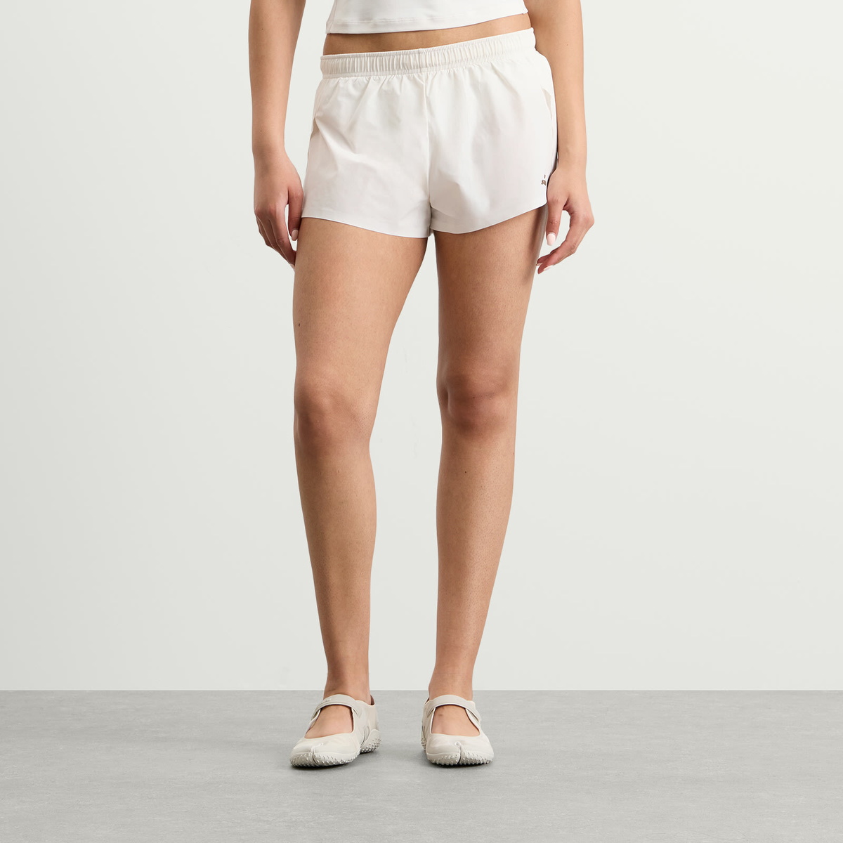 Nike Women's x SKIMS Stretch Nylon Runner Short in Ivory