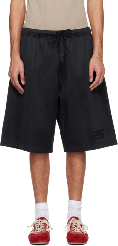 Photo: Fear of God ESSENTIALS Black Holiday Satin Fleece Relaxed Shorts