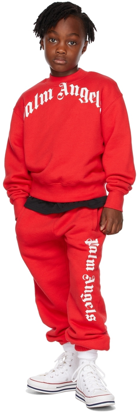 PALM ANGELS: jogging trousers with all over logo - Red