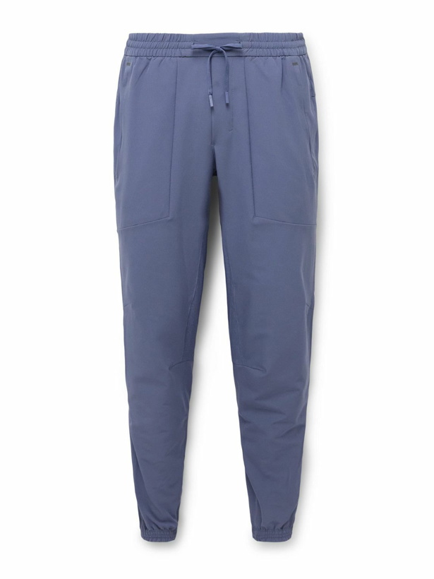 Photo: Lululemon - License to Train Slim-Fit Tapered Stretch Recycled-Shell Track Pants - Blue