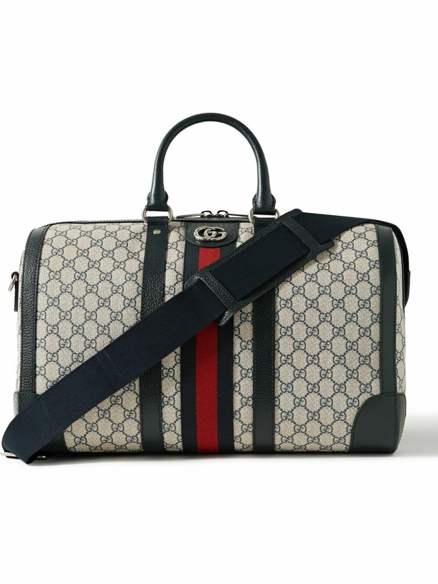 Photo: GUCCI - Leather- and Webbing-Trimmed Monogrammed Supreme Coated-Canvas Duffle Bag