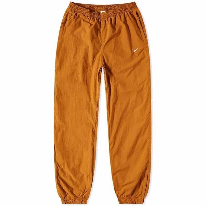 Photo: Nike Men's NRG Woven Track Pant in Desert Ochre/White