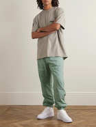 FEAR OF GOD ESSENTIALS - Tapered Logo-Appliquéd Padded Stretch-Shell Drawstring Trousers - Green