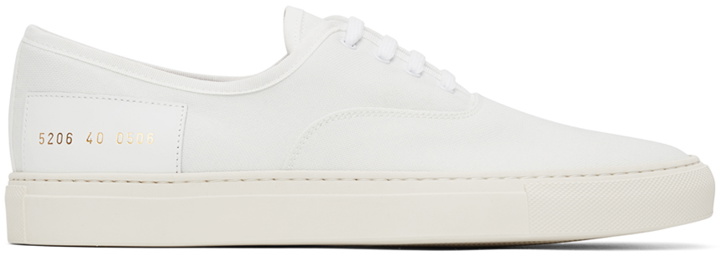 Photo: Common Projects White Canvas Four Hole Sneakers