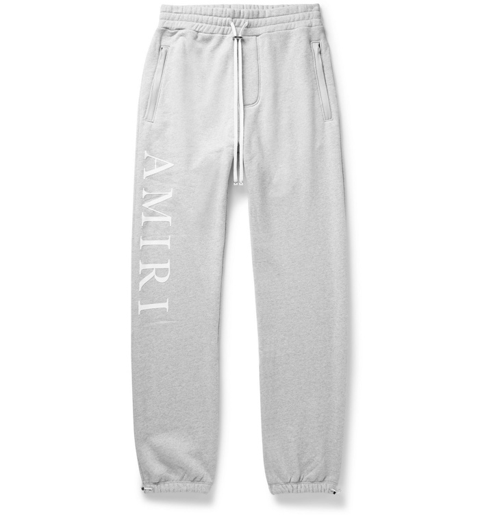 Photo: AMIRI - Tapered Logo-Print Mélange Loopback Cotton-Jersey Sweatpants - Gray