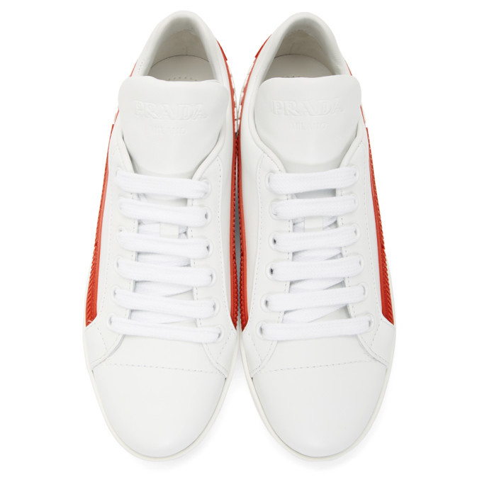 Prada white sneakers with best sale red stripe