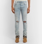 AMIRI - Thrasher Minus Skinny-Fit Paint-Splattered Distressed Stretch-Denim Jeans - Blue