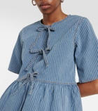 Ganni Striped bow-trimmed peplum denim blouse