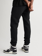 AMIRI - Tapered Logo-Print Cotton-Jersey Sweatpants - Black