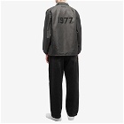 Fear of God ESSENTIALS Men's 1977 Nylon Coaches Jacket in Off Black