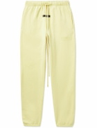 FEAR OF GOD ESSENTIALS - Tapered Logo-Flocked Cotton-Blend Jersey Sweatpants - Yellow