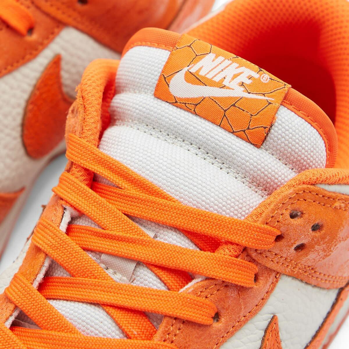 Nike Women's Dunk Low W Sneakers in Light Bone/Safety Orange