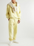 FEAR OF GOD ESSENTIALS - Tapered Logo-Flocked Cotton-Blend Jersey Sweatpants - Yellow
