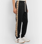 Gucci - Tapered Logo-Jacquard Webbing-Trimmed Tech-Jersey Track Pants - Black