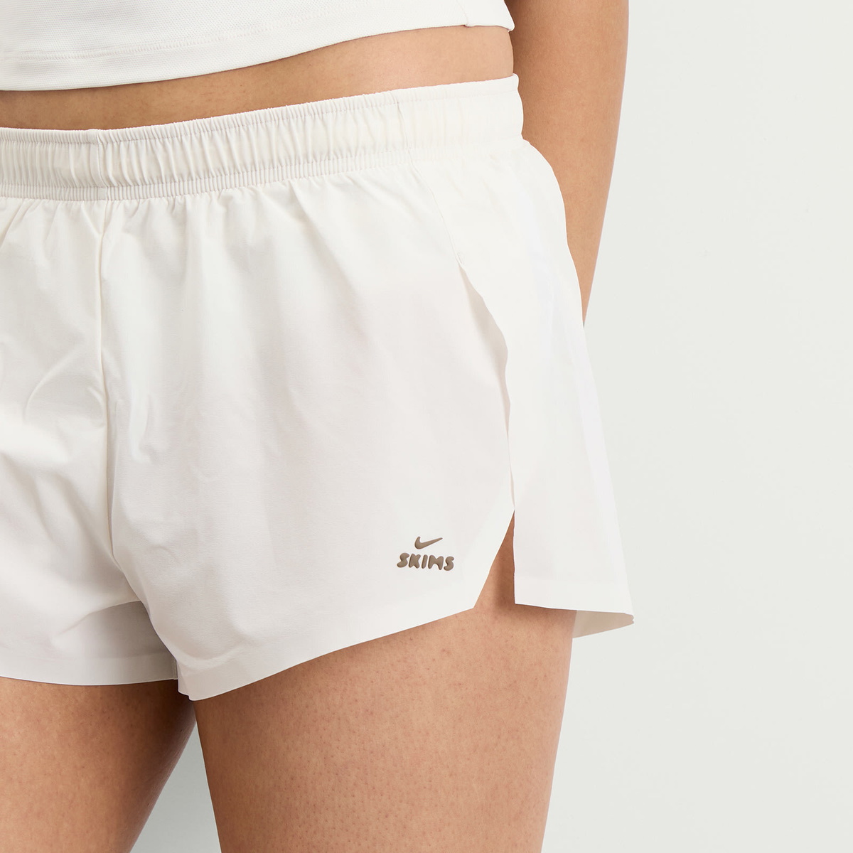 Nike Women's x SKIMS Stretch Nylon Runner Short in Ivory