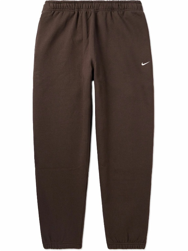 Photo: Nike - Solo Swoosh Tapered Logo-Embroidered Cotton-Blend Jersey Sweatpants - Brown