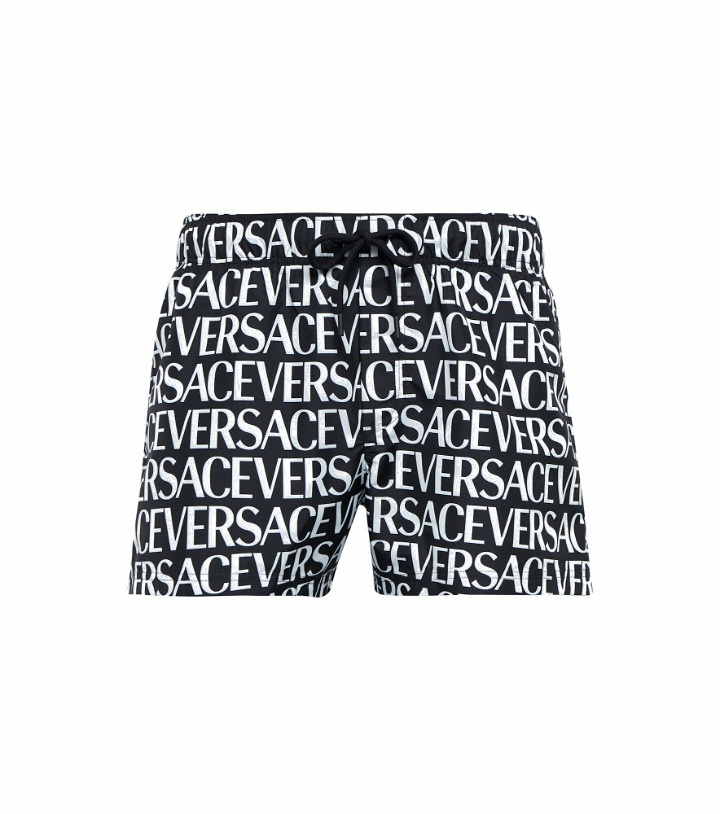 Photo: Versace - Logo-printed swim shorts