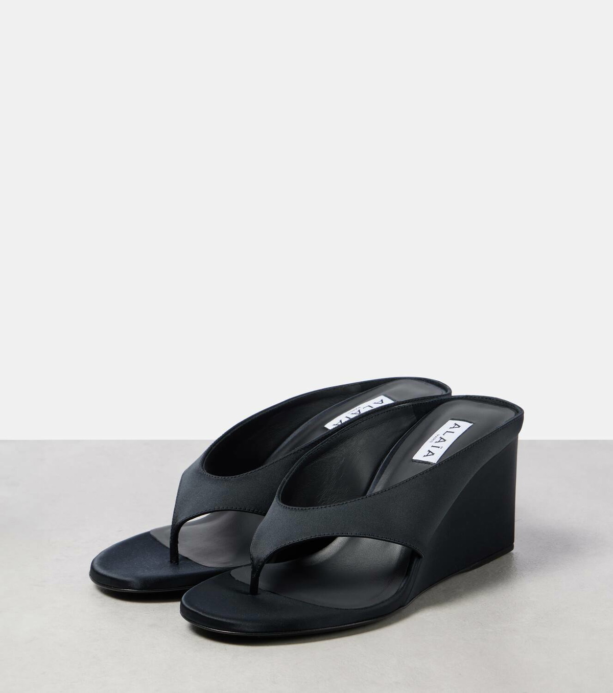 ALAIA WEDGE THONG SANDALS 25S IN BLACK SATIN